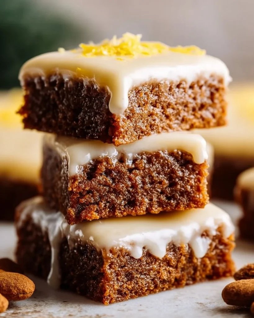 Chewy gingerbread bars with lemon glaze on a plate