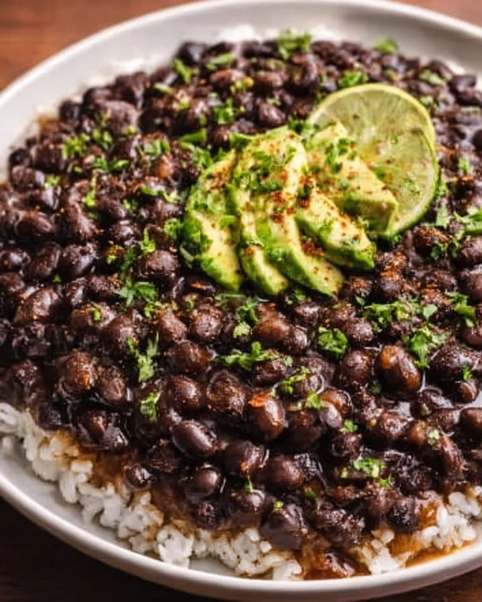 Delicious smoky black beans served in a bowl with fresh herbs and spices