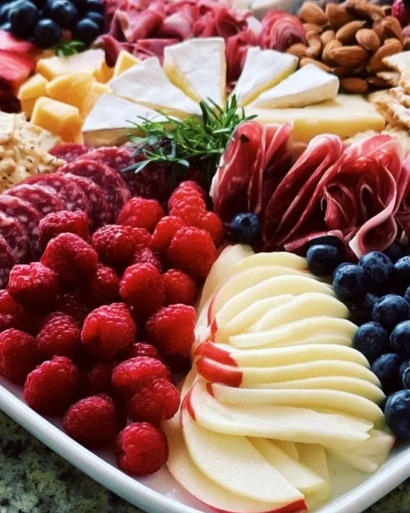 4th of July charcuterie board with red, white, and blue snacks for summer celebrations