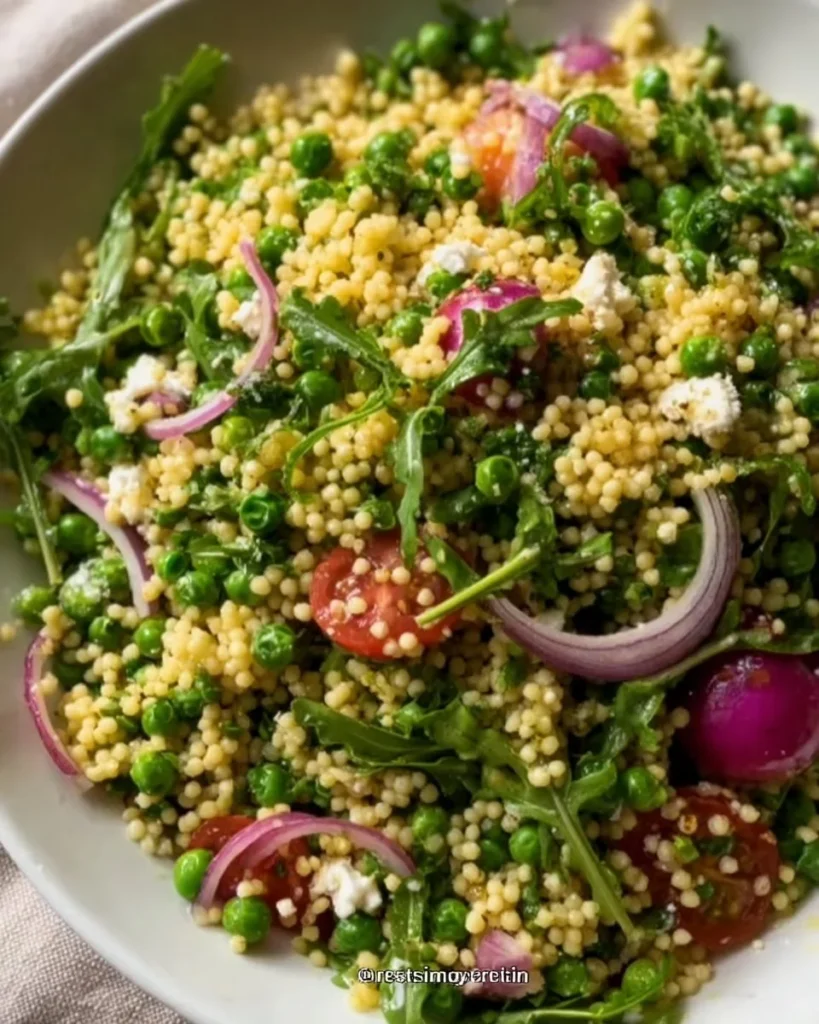 Colorful couscous salad with fresh vegetables and herbs