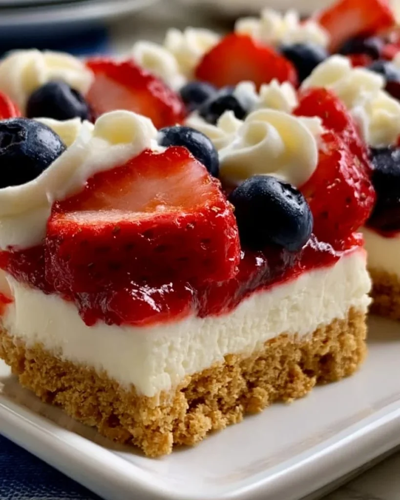 No-bake flag cheesecake bars decorated with strawberries and blueberries