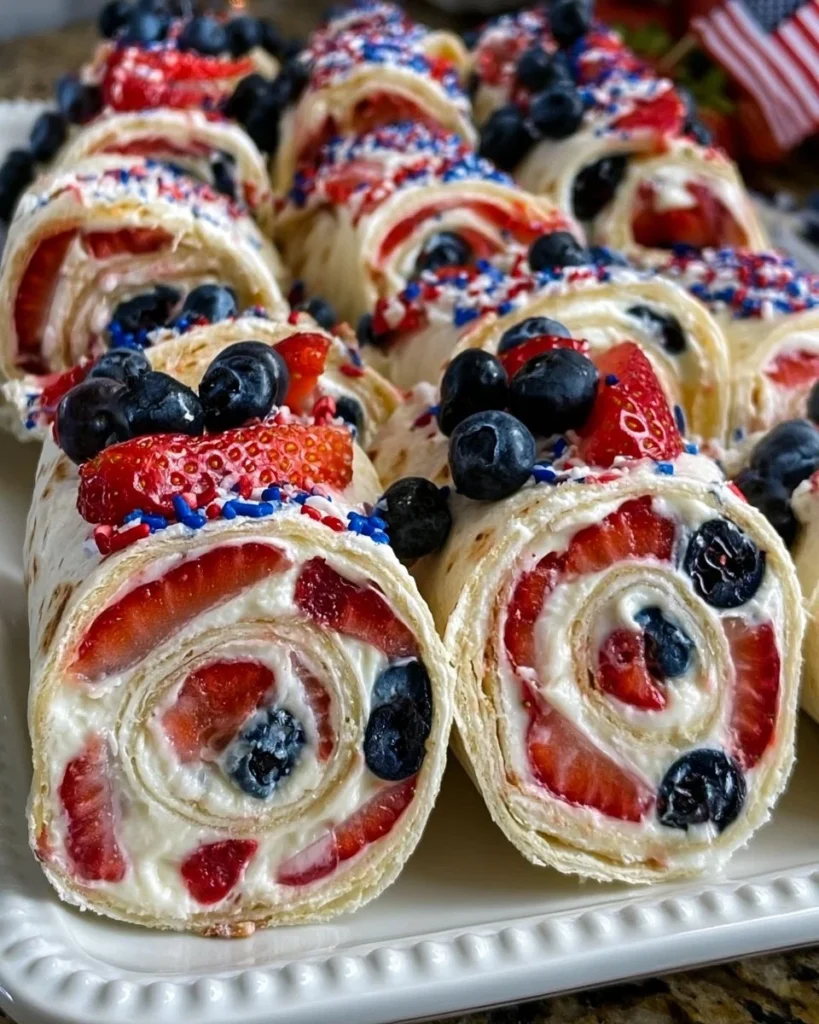 Colorful patriotic cream cheese pinwheels served on a platter